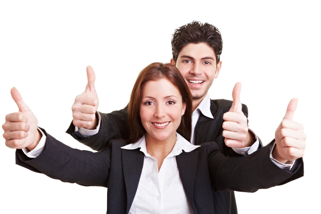 Business people holding thumbs up